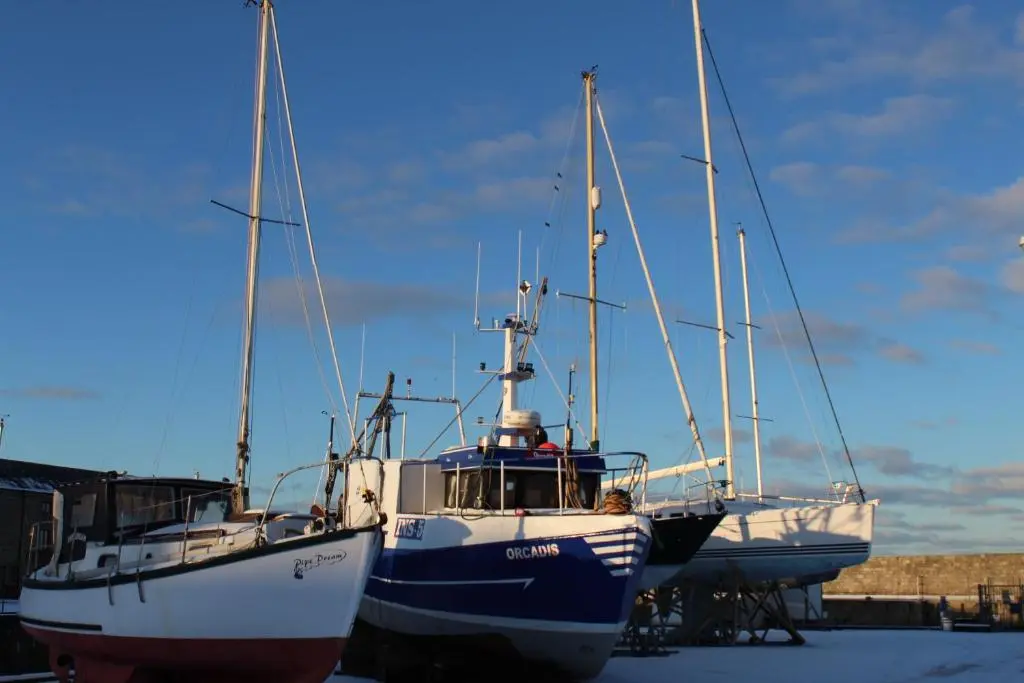 three boats are parked next to each other at Beachfront Panoramic Seaview Free Wifi & Parking in Lossiemouth