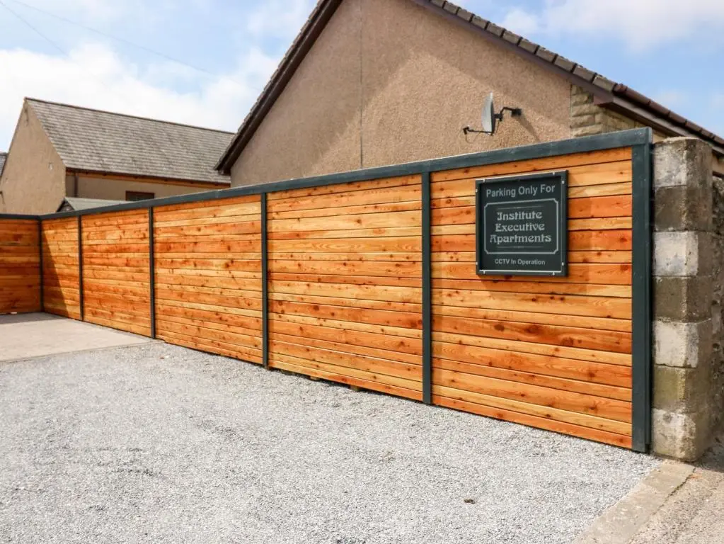 a wooden garage door with a sign on it at The Marriage Room at The Institute Executive Apartments in Keith