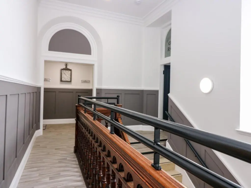 a view of a staircase in a building with a stair case at The Clock Tower at The Institute Executive Apartments in Keith