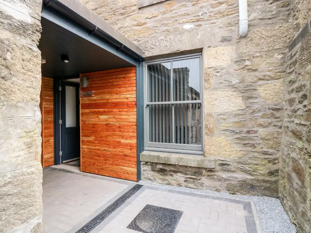 a building with a wooden door with a window at The Court Room at The Institute Executive Apartments in Keith