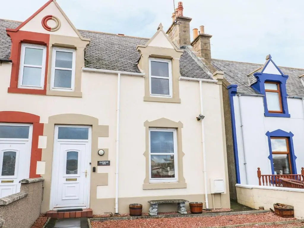 a white house with a red roof at Harbour View in Buckie