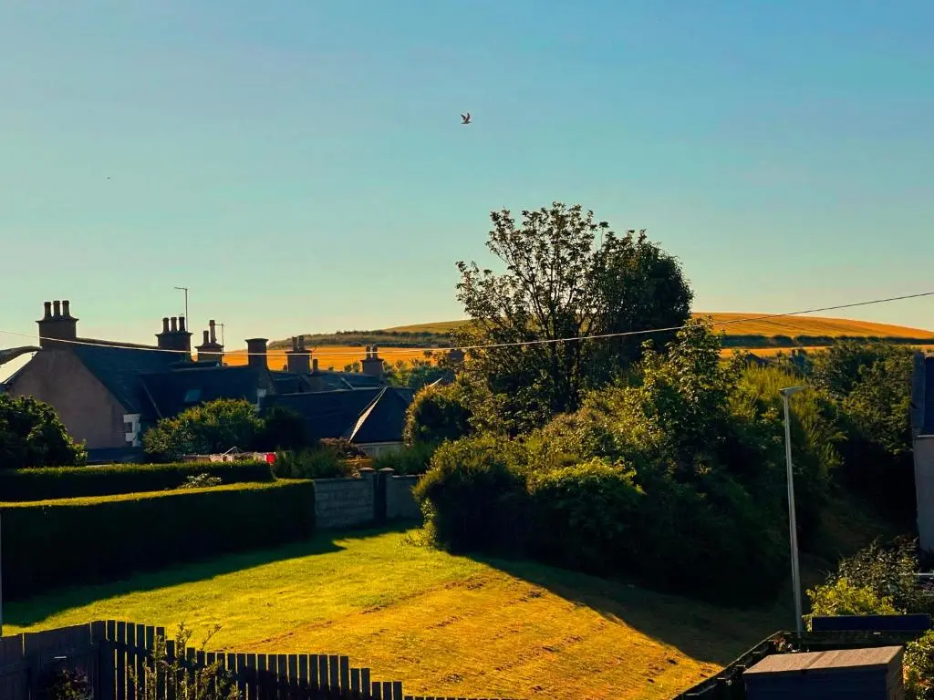 a view of a yard with a fence and a house at Spacious 2 Bedroom Home in Picturesque Cullen in Cullen
