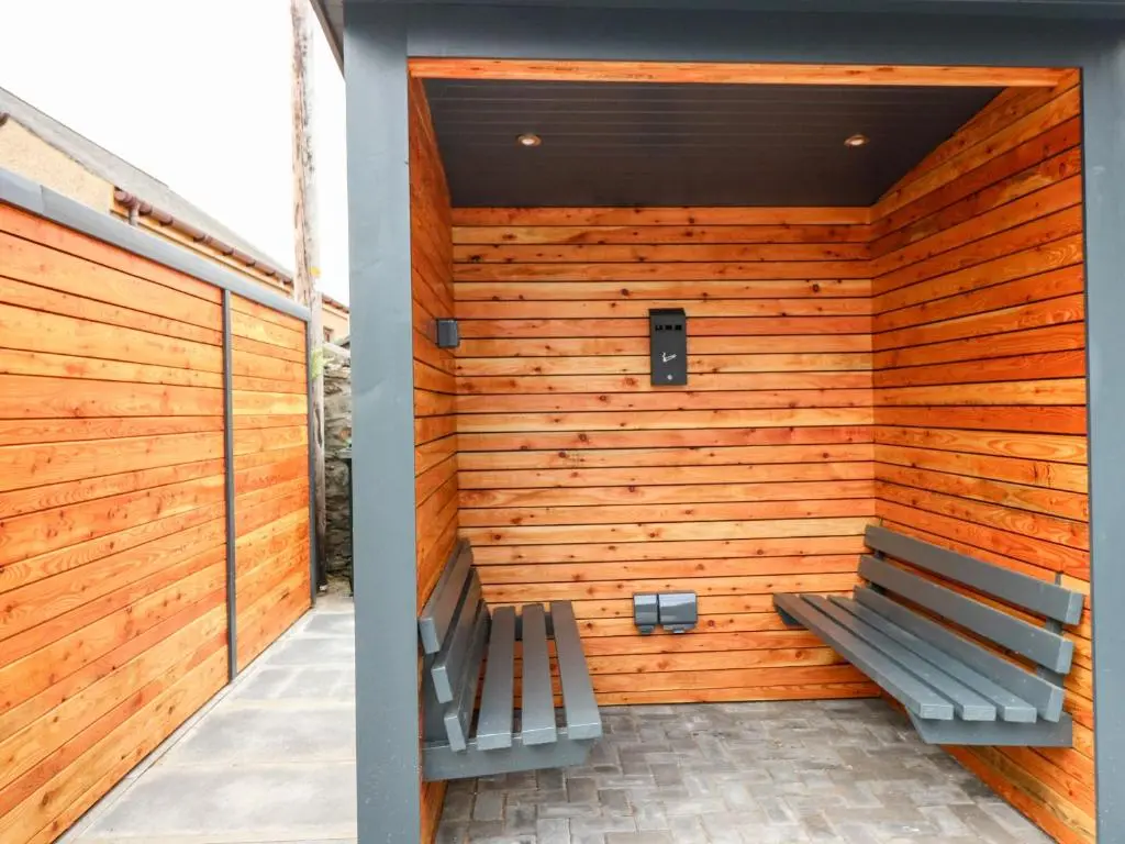 a wooden wall with a bench in front of it at Council Chambers at The Institute Executive Apartments in Keith