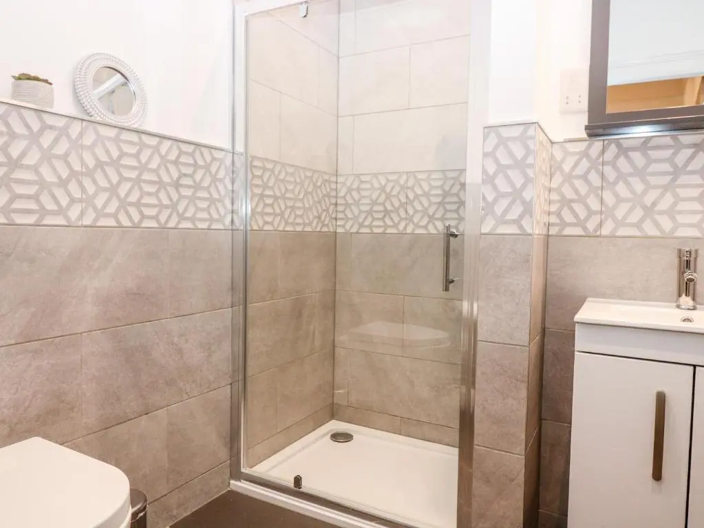 a bathroom with a shower and a toilet at Council Chambers at The Institute Executive Apartments in Keith