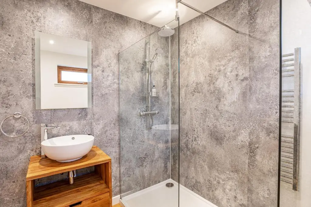a bathroom with a sink and a shower at Thistle Lodge 19 with Hot Tub in Belladrum