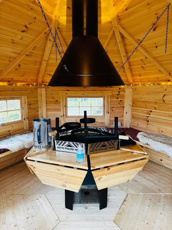 a kitchen with a stove in a wooden cabin at Highland Premier Glamping Pods in Beauly