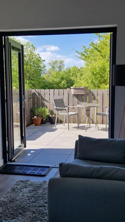 a living room with a couch and a patio at Fyrish View in Dingwall