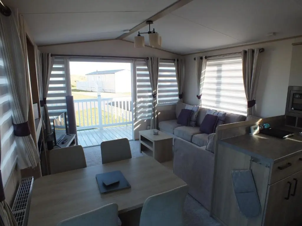 a living room with a couch and a table at Beachside Lighthouse 14 in Lossiemouth