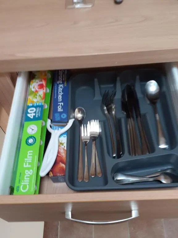 a drawer filled with utensils in a cabinet at RICK'S RETREAT static caravan near the beach with free wifi in Lossiemouth