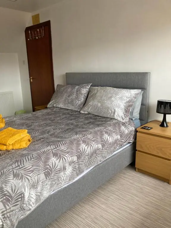 a bed in a room with a nightstand and a bed sidx sidx at No 22 in Banff