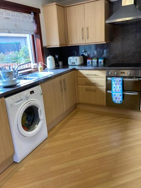 a kitchen with a washing machine and a sink at No 22 in Banff