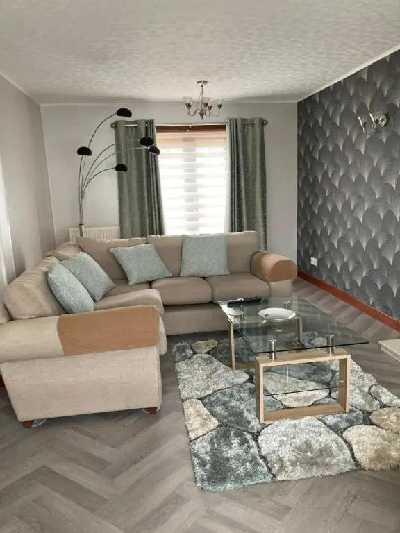 a living room with a couch and a glass table at No 22 in Banff