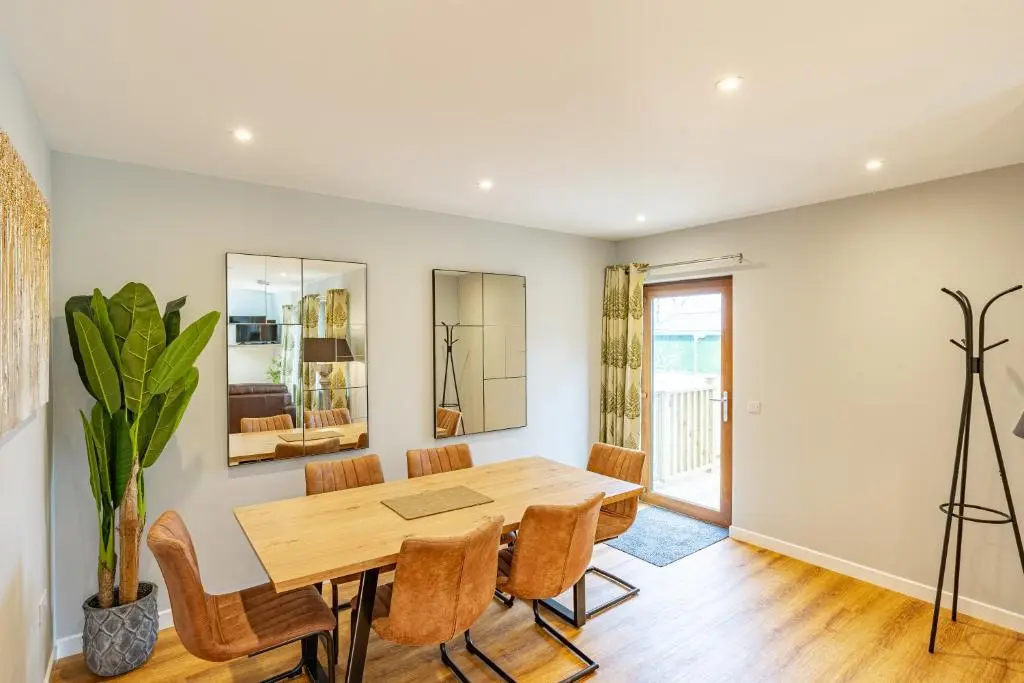 a dining room with a wooden table and chairs at Monarch Lodge 14 with Hot Tub in Belladrum