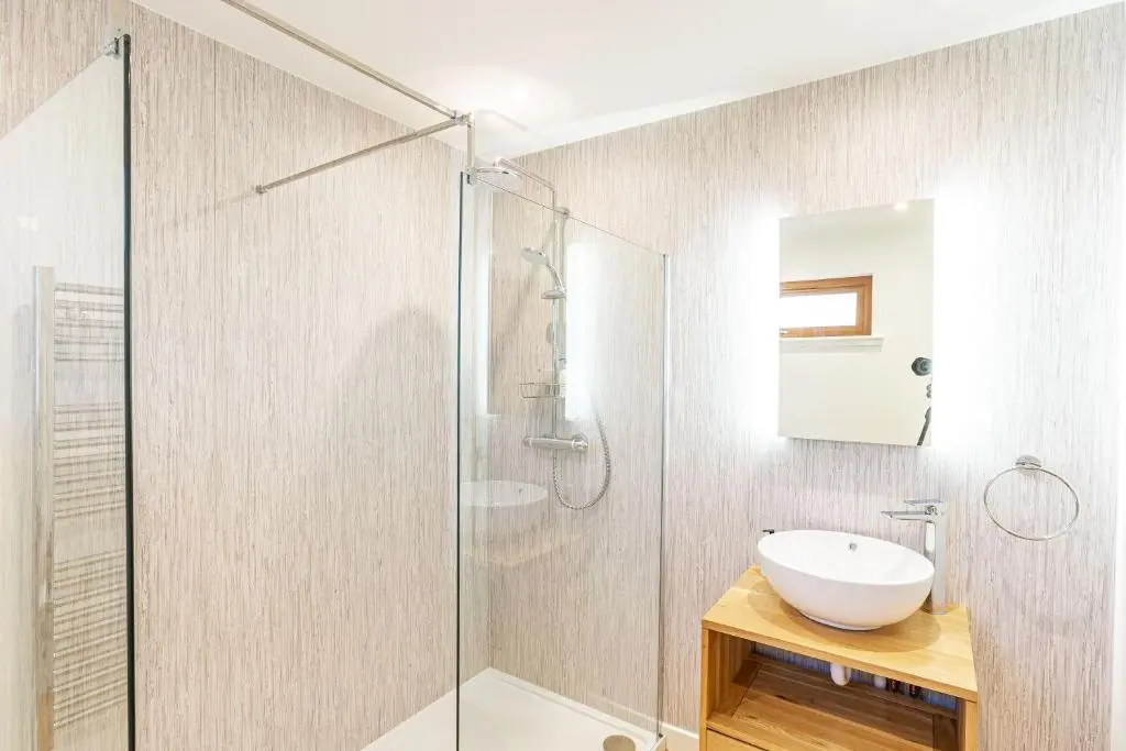 a bathroom with a glass shower and a sink at Thistle Lodge 22 with Hot Tub in Belladrum