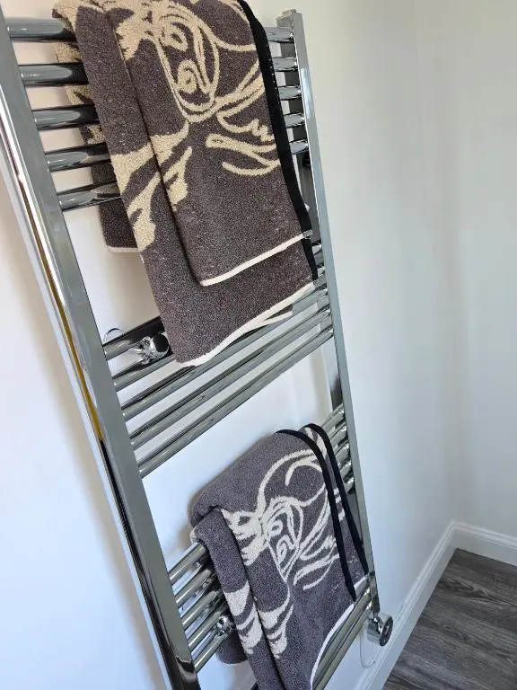 a towel rack with towels on it at Beautiful studio chalet in the Highlands in Inverness