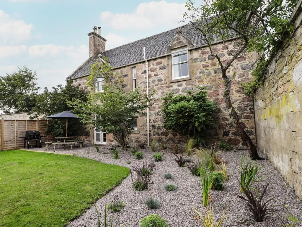 an old stone house with a garden in front of it at Garden House - Brodie Castle in Forres