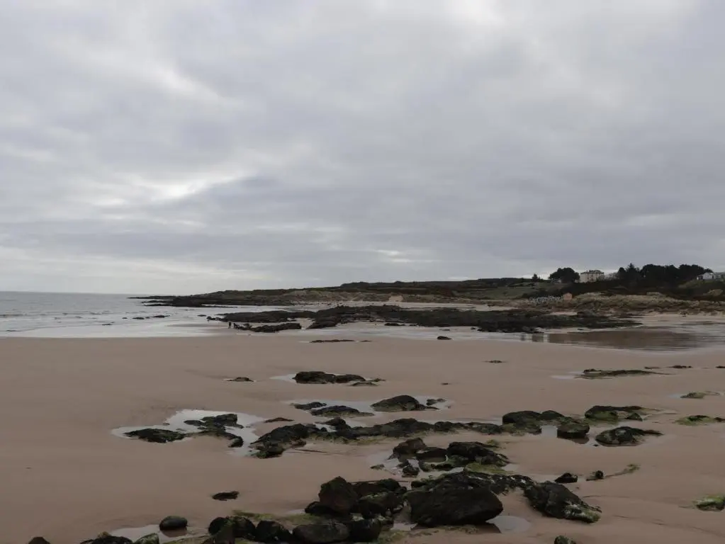 a beach with rocks in the sand and the ocean at Seaview at The Doocot in Elgin