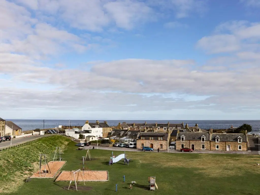 a view of a town with houses and the ocean at Seaview at The Doocot in Elgin