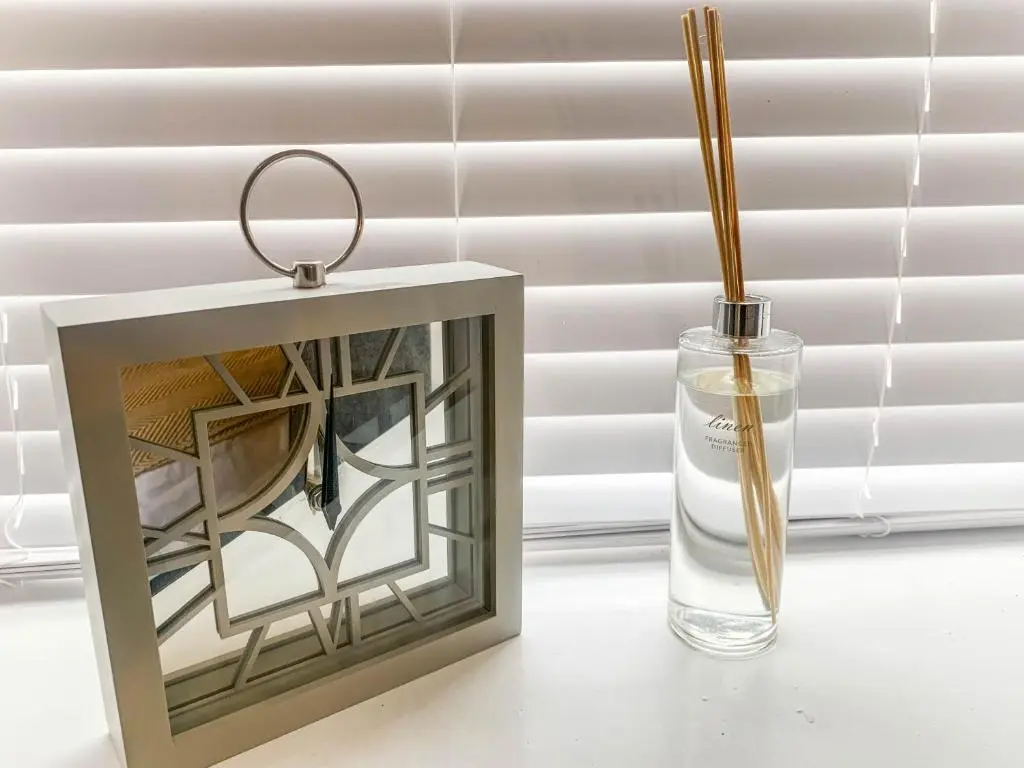 a lantern and a glass vase with a candle at The Rosebery Retreat By The Castle 1-Bed Apartment in Inverness