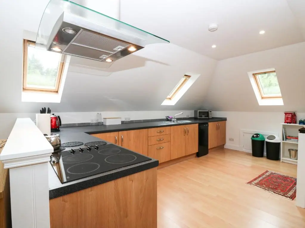 a kitchen with a stove top oven in a room at Hayloft in Peterhead