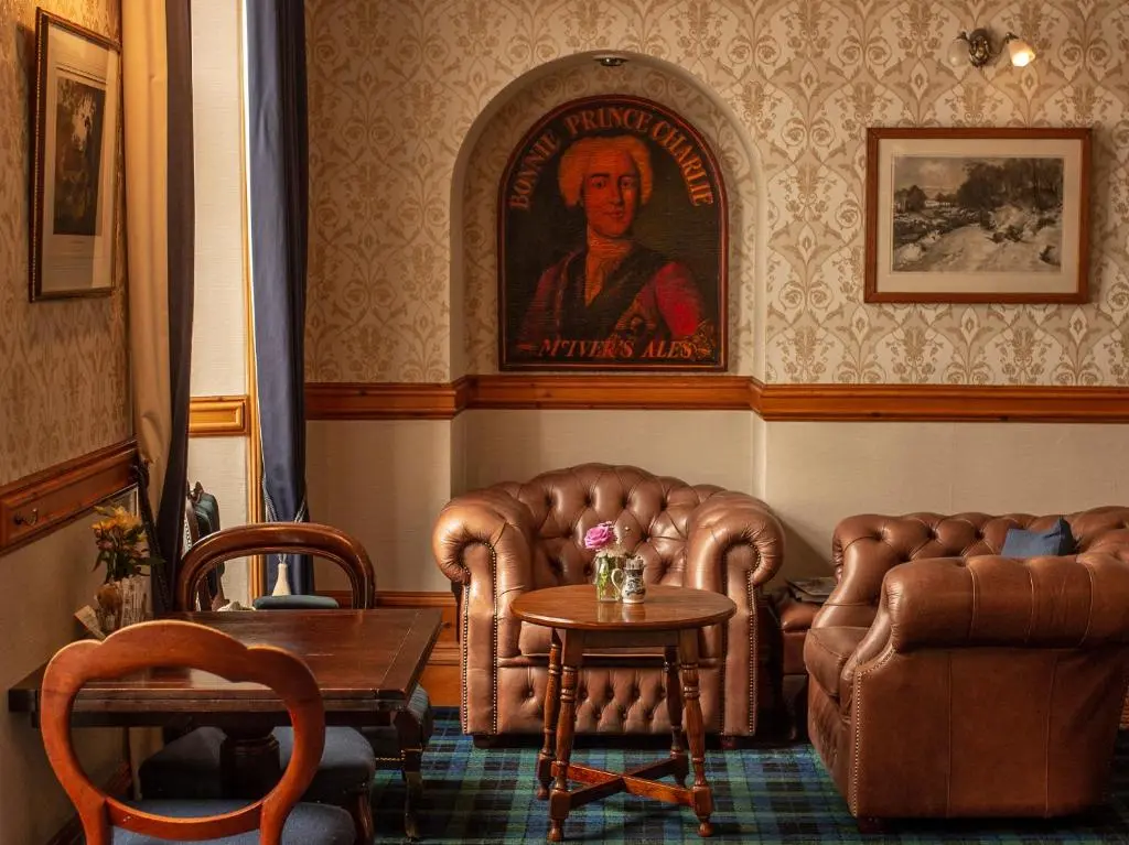 a living room with two chairs and a table at Saplinbrae Hotel and Lodges in Mintlaw