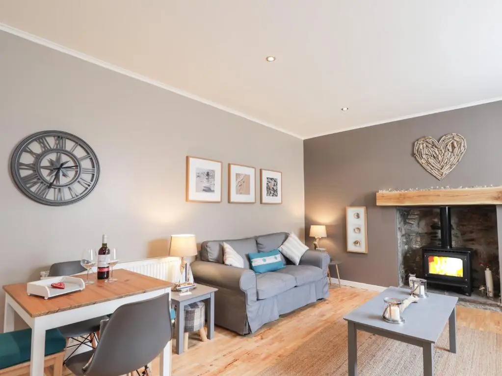 a living room with a couch and a table at 18b New Street in Buckie