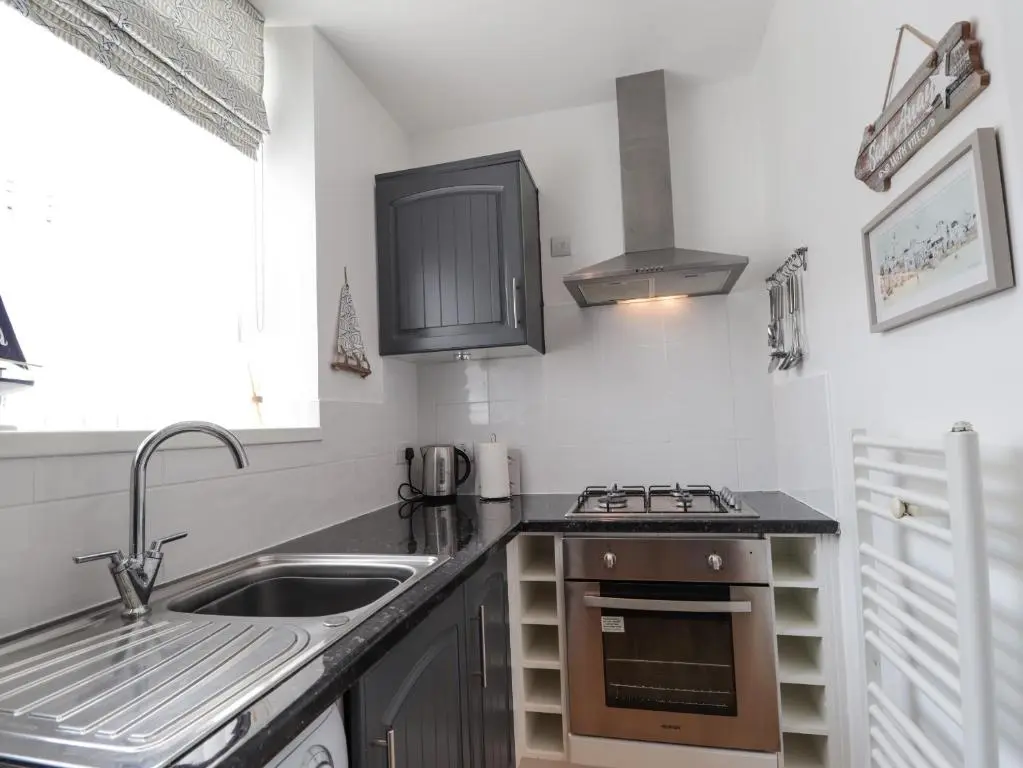 a kitchen with a sink and a stove at 18b New Street in Buckie