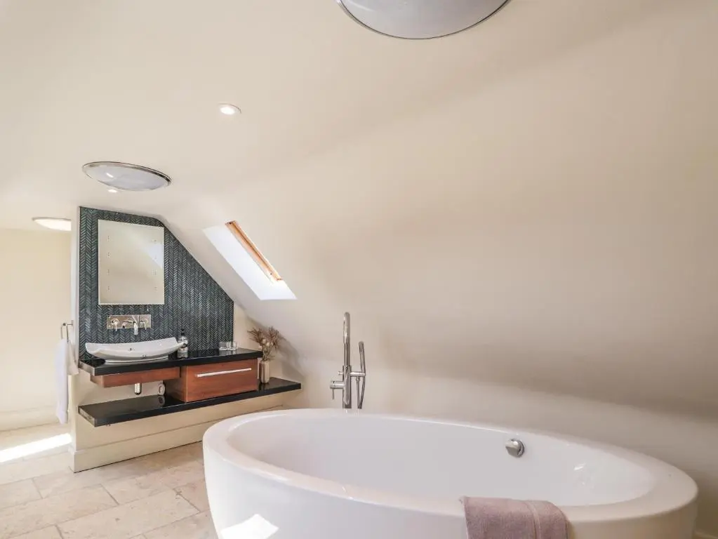 a white bathroom with a tub and a sink at Mary Ann Villa in Inverness