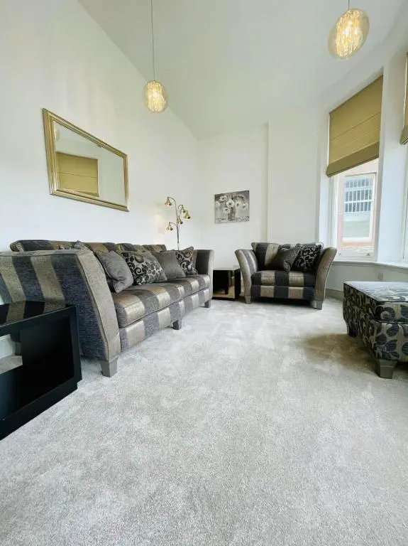 a living room with a couch and a tv at No 49 a spacious executive apartment in Inverness in Inverness