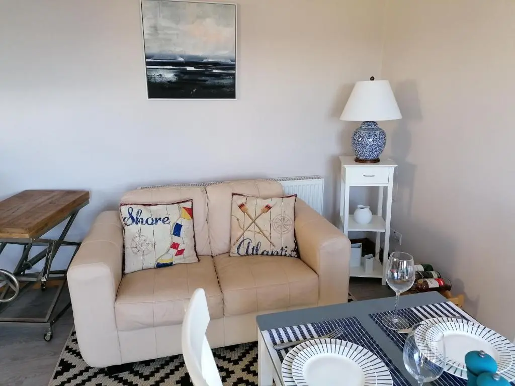 a living room with a couch and a table at Sunnyside House in Gardenstown