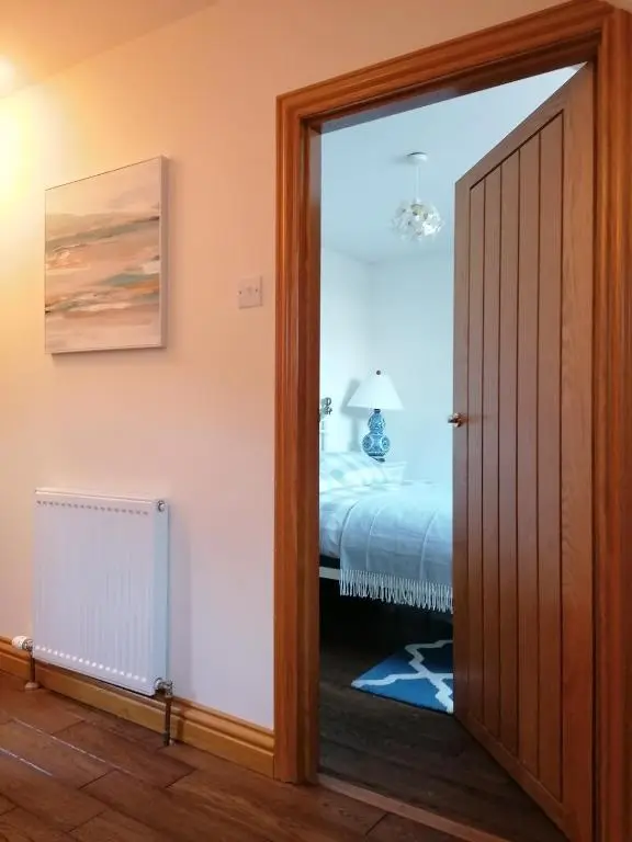 a door leading into a bedroom with a bed at Sunnyside House in Gardenstown