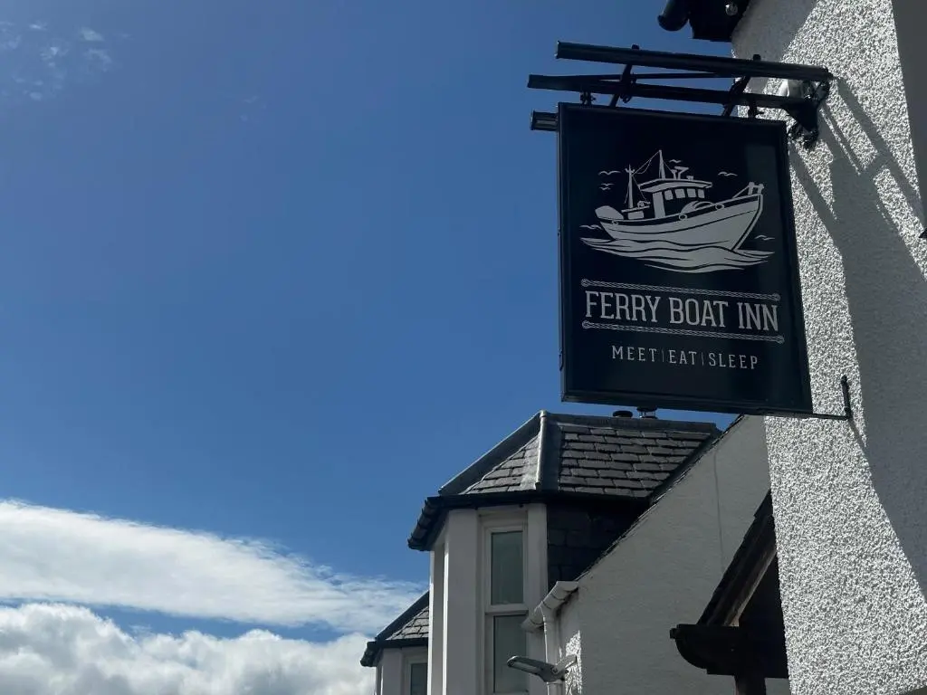 a sign for a ferry boat inn on the side of a building at The Ferry Boat Inn in Ullapool