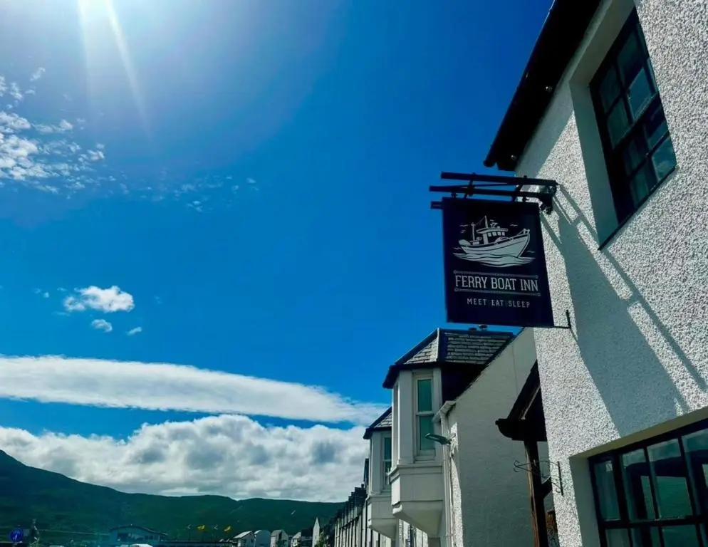 a sign for a boat inn on the side of a building at The Ferry Boat Inn in Ullapool