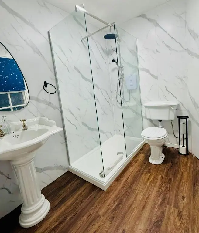 a bathroom with a shower and a toilet and a sink at The Ferry Boat Inn in Ullapool