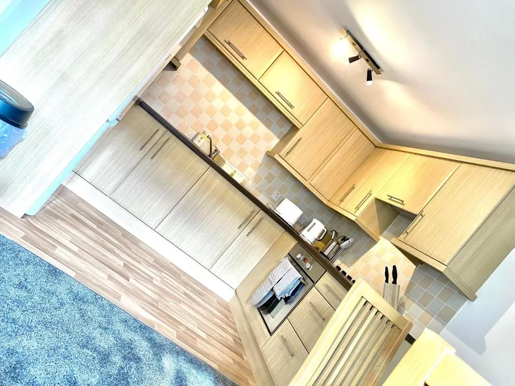 an overhead view of a kitchen with wooden cabinets at Modern Spacious, Near Marina - Commerce Street, Lossiemouth - Free Parking, WiFi in Lossiemouth