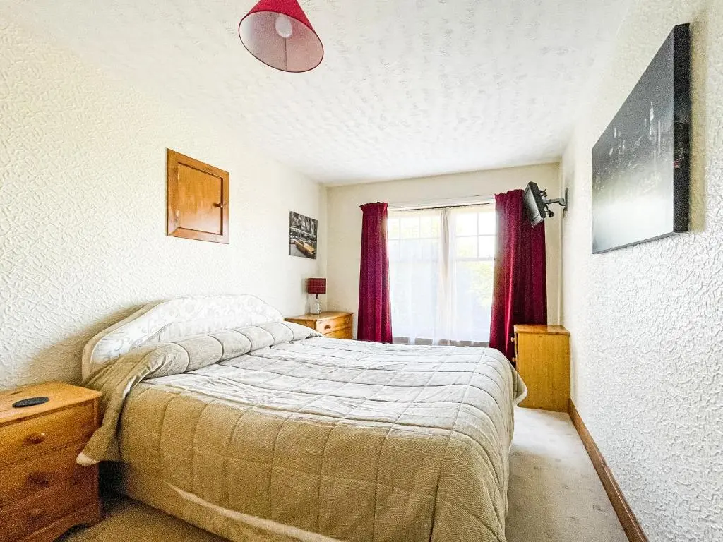 a bedroom with a bed and a window at Fourpenny Studio - Uk34745 in Embo