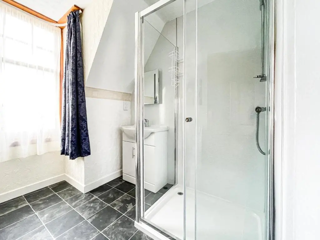 a bathroom with a shower and a toilet at Fourpenny Cottage - Uk34744 in Embo
