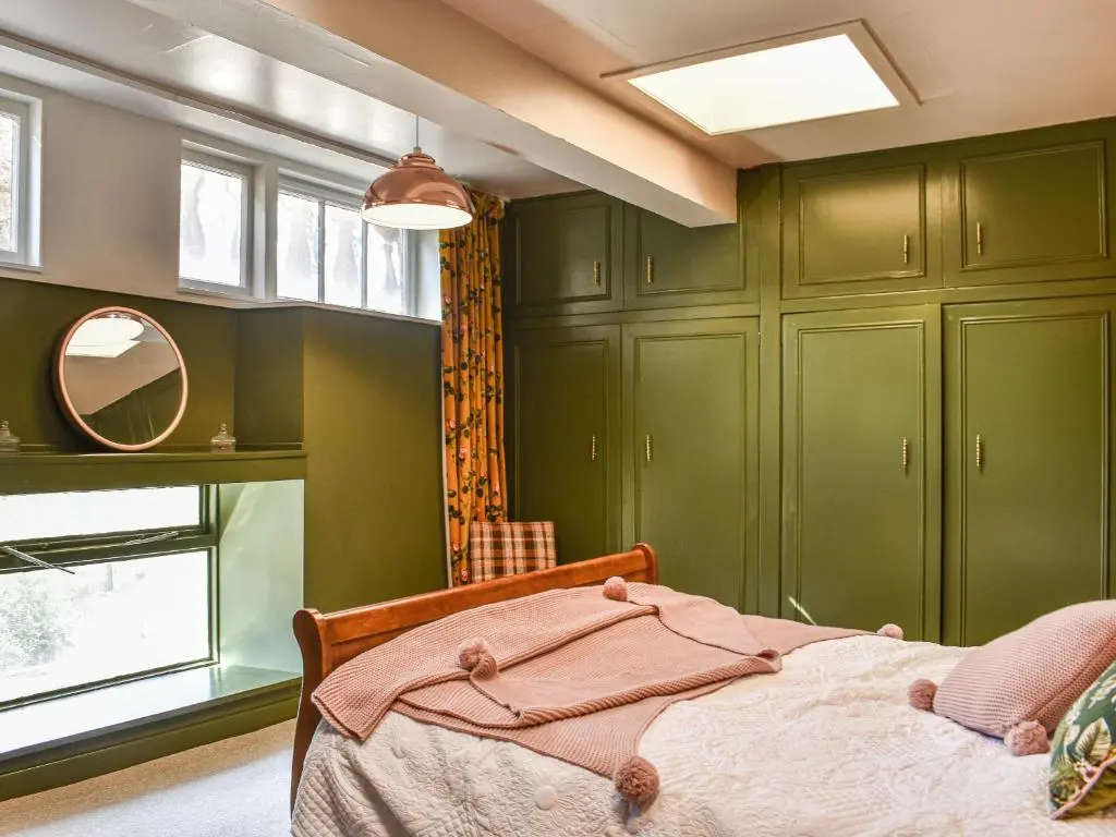 a bedroom with green cabinets and a bed at Hayfield - Uk35890 in Turriff