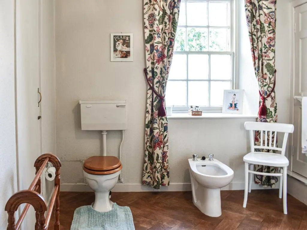 a bathroom with a toilet and a sink and a window at Hayfield - Uk35890 in Turriff