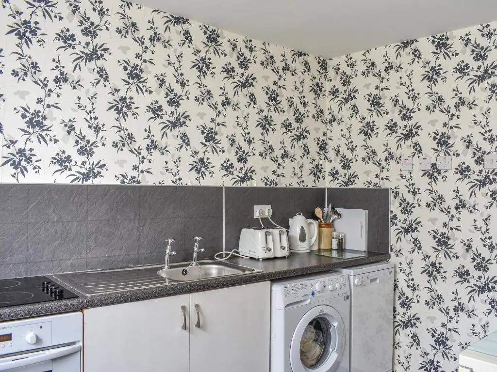 a kitchen with a sink and a washing machine at Hayfield - Uk35890 in Turriff