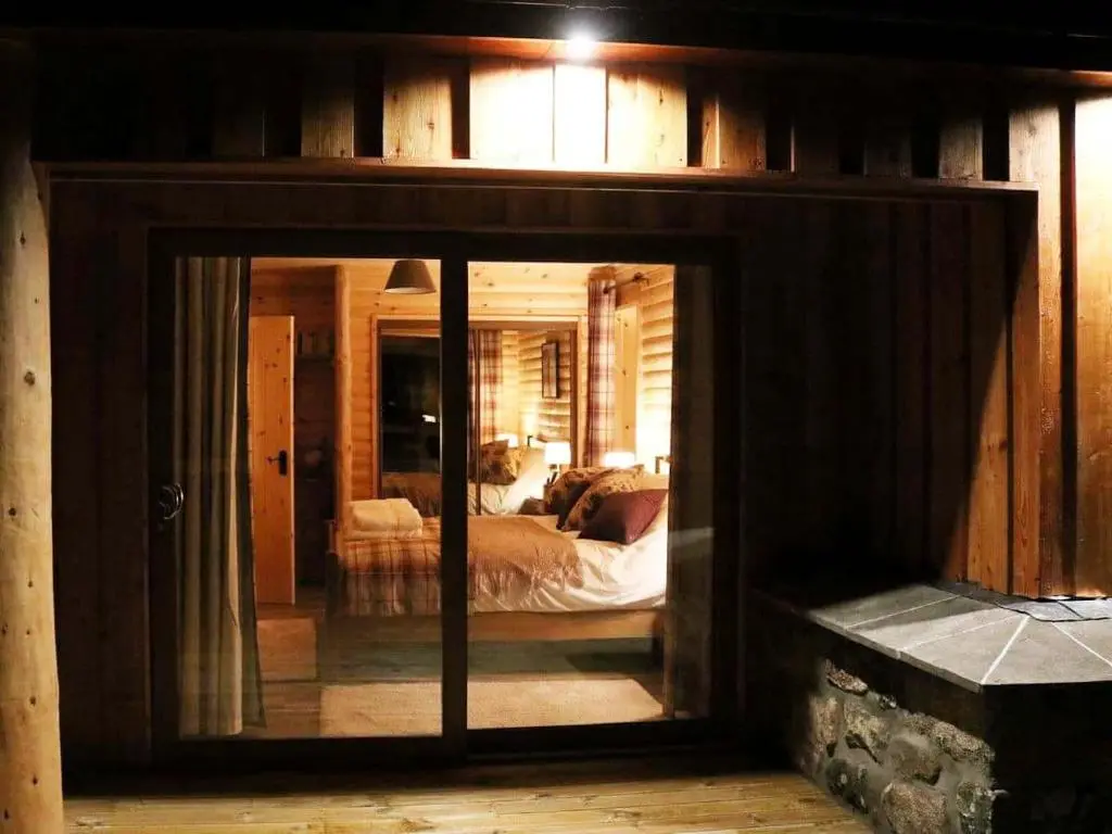 a room with a bedroom with a bed in it at Red Kite & Osprey Lodges in Rhilochan