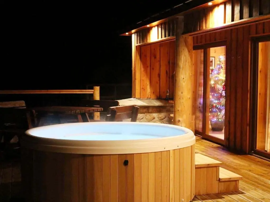 a hot tub in the middle of a room at Red Kite & Osprey Lodges in Rhilochan