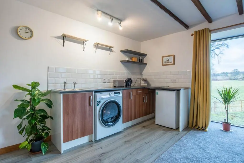 a kitchen with a washer and a washing machine at Beautiful Character House in Muir of Ord in Muir of Ord