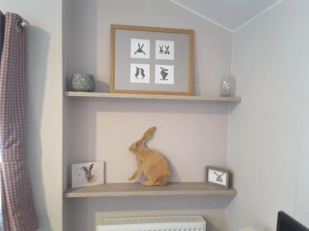 a shelf in a room with a stuffed rabbit on it at No 46 Coorie-in in Boat of Garten