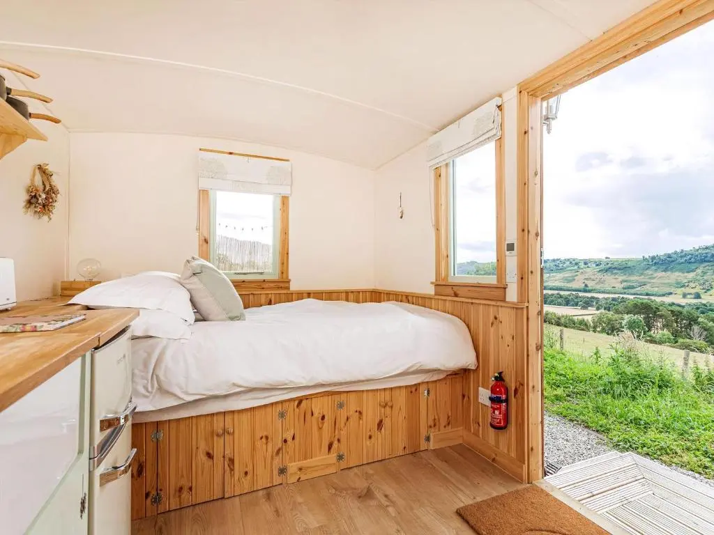 a bedroom with a bed and a window at Woodside Hut 2 - Uk36106 in Auchterneed