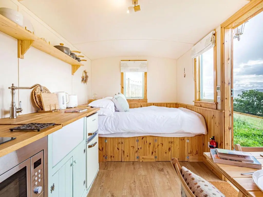 a bedroom with a bed in the middle of it at Woodside Hut 1 - Uk36105 in Auchterneed