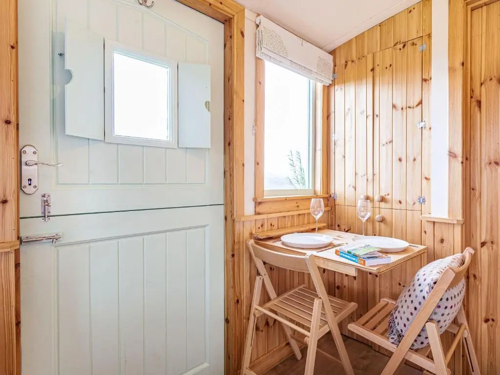a small room with a table and two chairs at Woodside Hut 1 - Uk36105 in Auchterneed