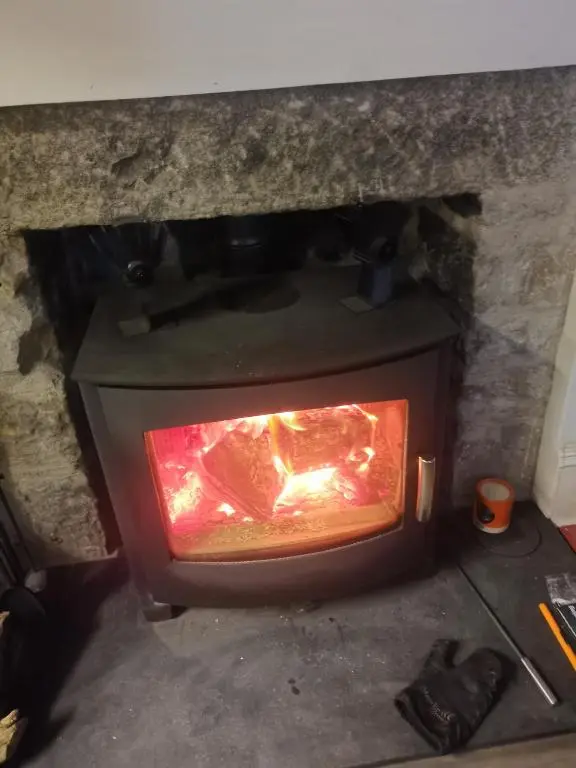 a stone oven with a fire inside of it at Dalwhinnie Old School Hostel in Dalwhinnie