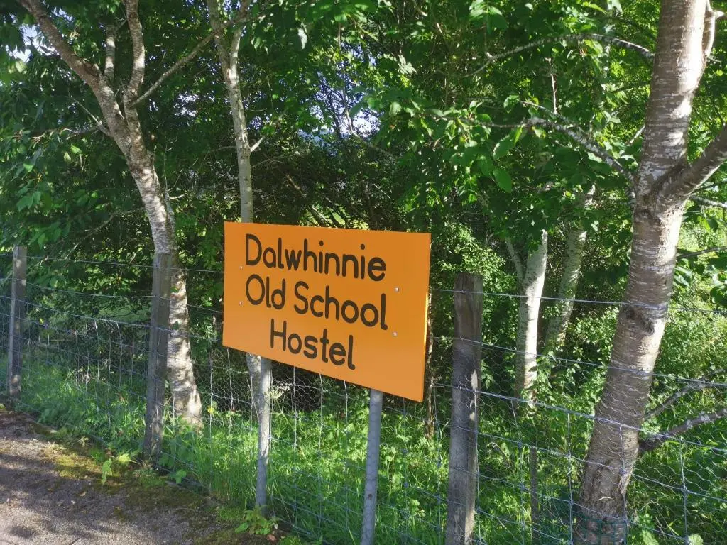 a sign on a fence that readsdharma old school hospital at Dalwhinnie Old School Hostel in Dalwhinnie