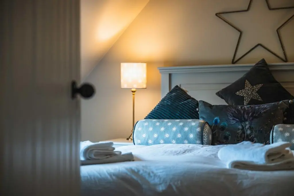 a bedroom with a bed with a star on the wall at Bramble Cottage in Turriff